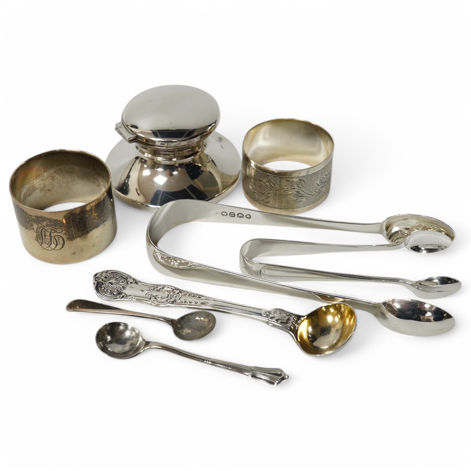 A modern silver capstan inkwell, two silver napkin rings and five items of silver cutlery including a pair of William IV sugar tongs. Condition - fair to good